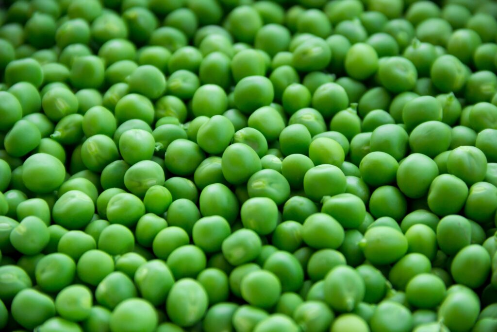 A vibrant close-up image of fresh, organic green peas for healthy eating.