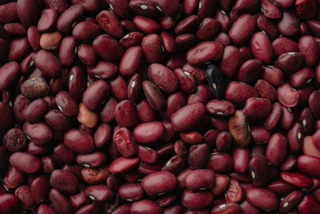 A detailed close-up of red kidney beans, showcasing texture and color. Perfect for food and agriculture themes.